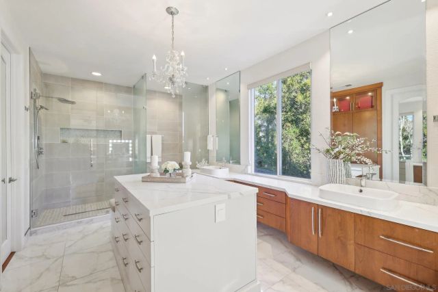 a bathroom with a double vanity sink mirror and shower