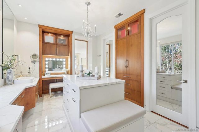 a large white kitchen with a large window
