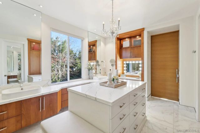 a bathroom with a sink double vanity and a large mirror