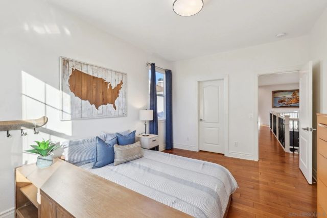 a bedroom with a bed and a potted plant