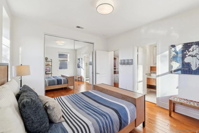 a bedroom with furniture and a wooden floor