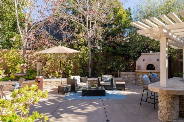 a outdoor space with patio couch and a fire pit