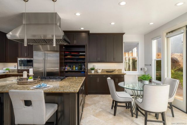 a kitchen with a table chairs stove and cabinets