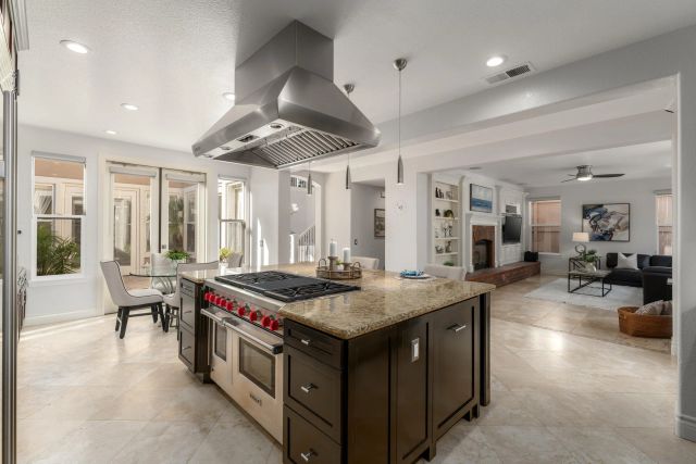 a kitchen that has a lot of cabinets a sink and a stove in it