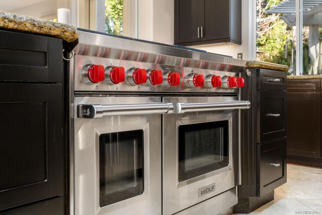 a stove top oven sitting inside of a kitchen