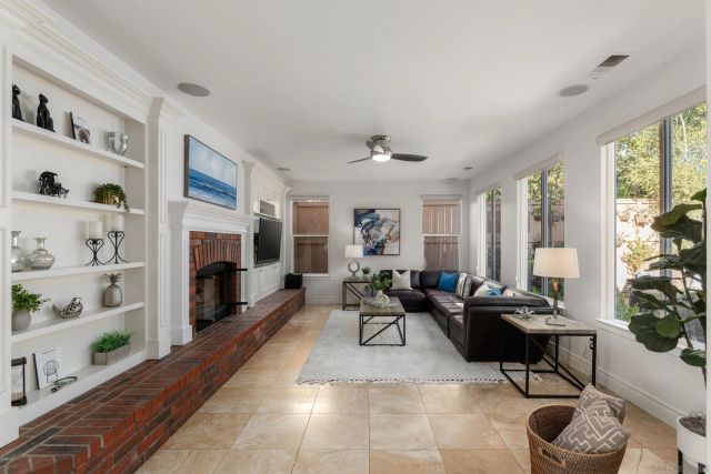a living room with furniture fireplace and window
