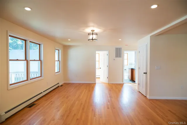 wooden floor in an empty room with a window and wooden floor