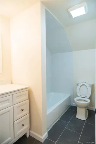 a bathroom with a toilet a sink and a mirror