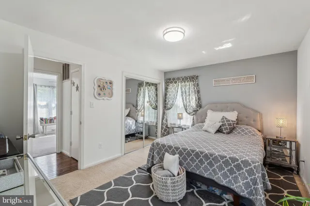 a bedroom with a bed and a mirror