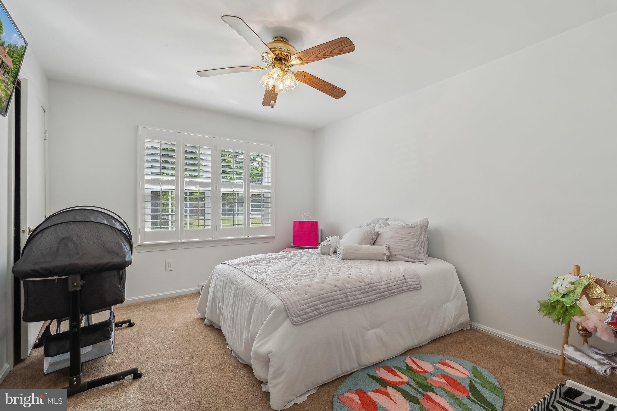 5232 Sumerduck Road Sumerduck, VA 22742 - Photo 18 of 40 a bedroom with a bed a dresser and a chandelier