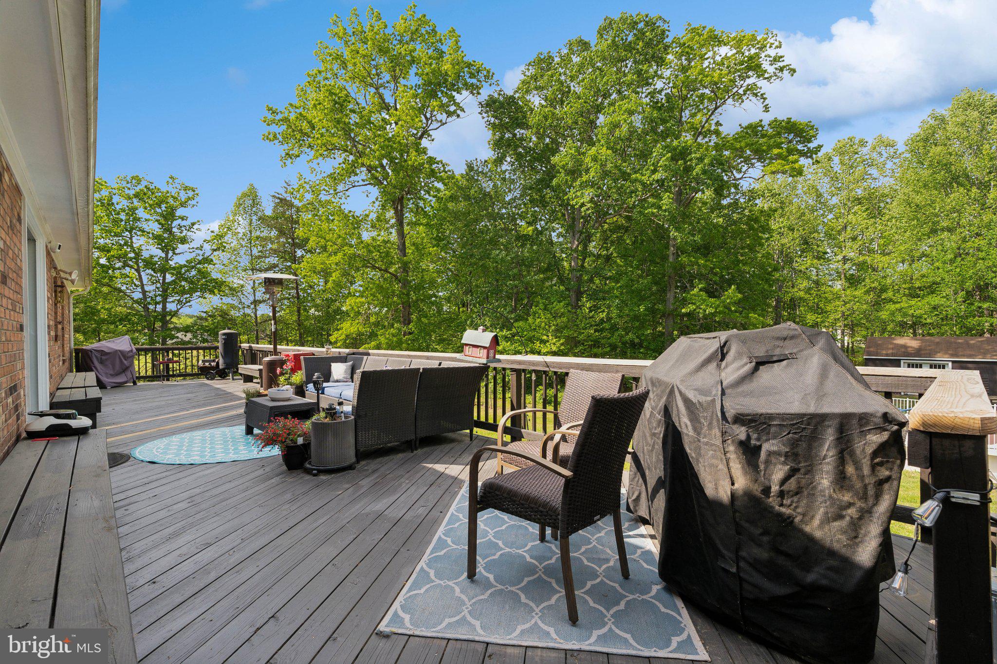 5232 Sumerduck Road Sumerduck, VA 22742 - Photo 37 of 40 a view of a patio with table and chairs with wooden floor and fence