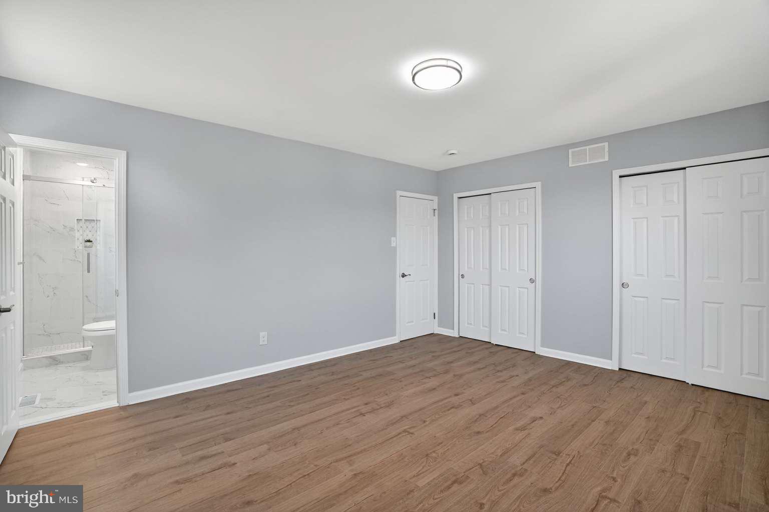 1841 Buck Road Feasterville-Trevose, PA 19053 - Photo 17 of 37 an empty room with wooden floor and windows