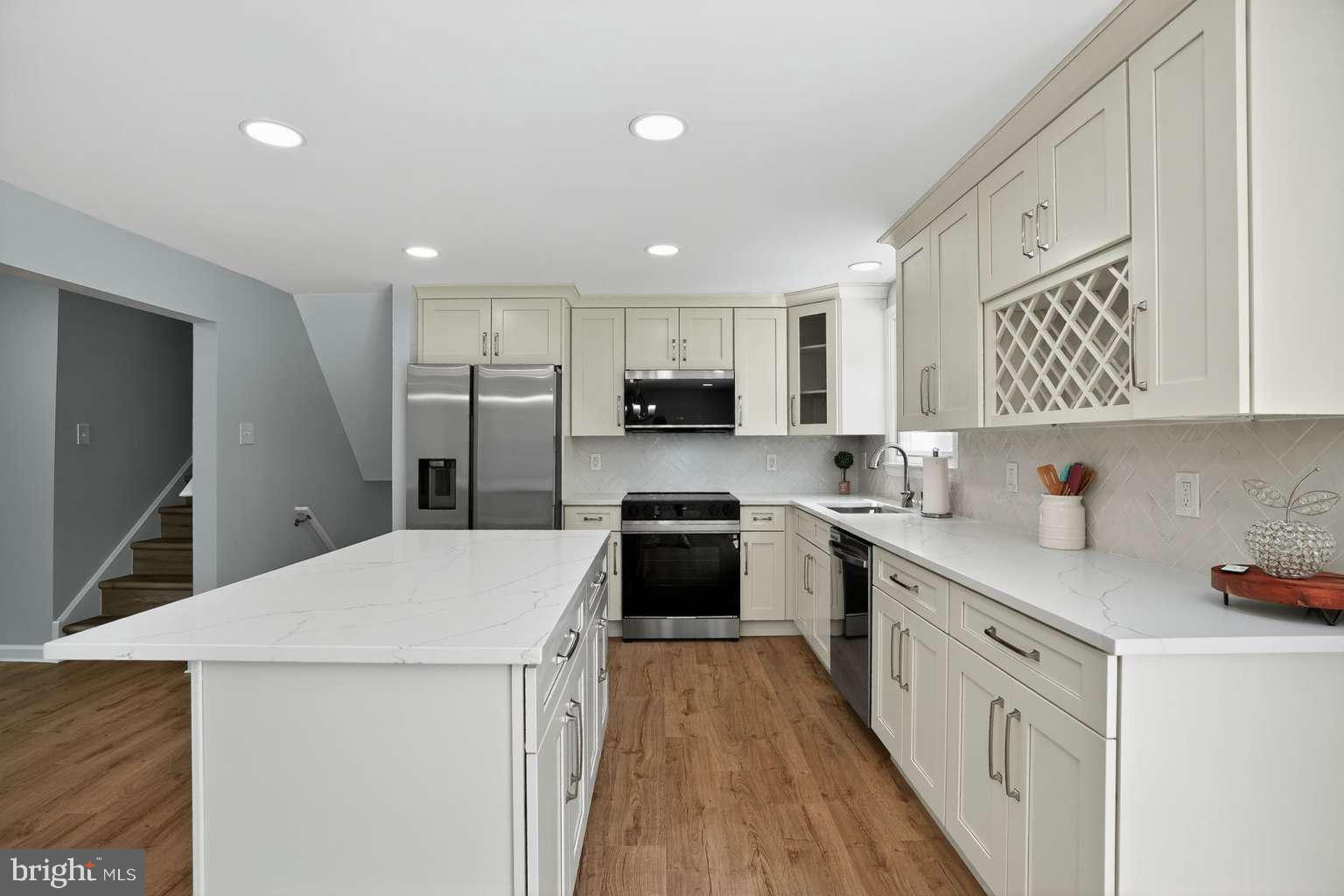 1841 Buck Road Feasterville-Trevose, PA 19053 - Photo 2 of 37 a kitchen with granite countertop white cabinets and stainless steel appliances