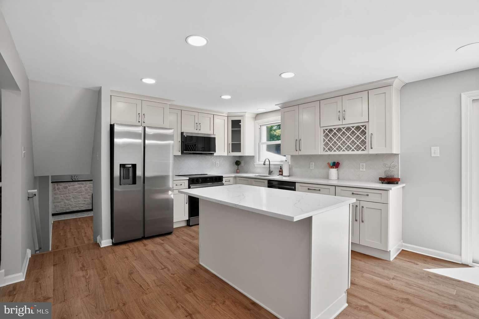 1841 Buck Road Feasterville-Trevose, PA 19053 - Photo 3 of 37 a kitchen with white cabinets and stainless steel appliances