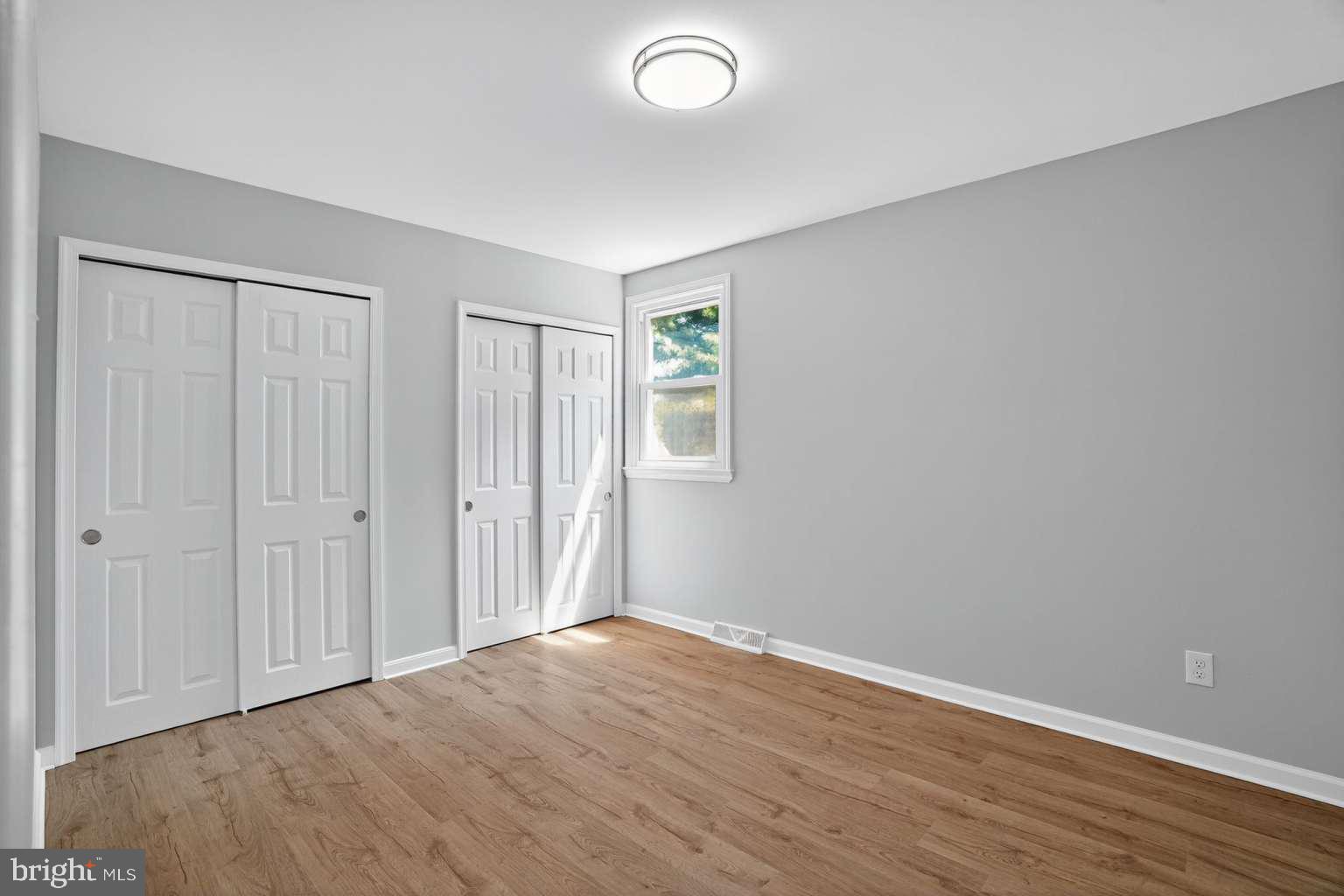 1841 Buck Road Feasterville-Trevose, PA 19053 - Photo 33 of 37 a view of an empty room with wooden floor and a window