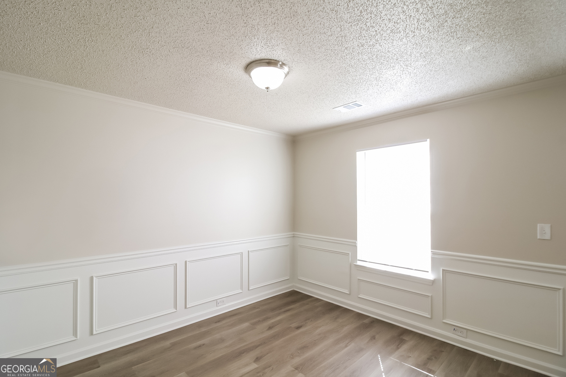 165 Colser Drive Covington, GA 30016 - Photo 12 of 17 a view of an empty room with wooden floor and window