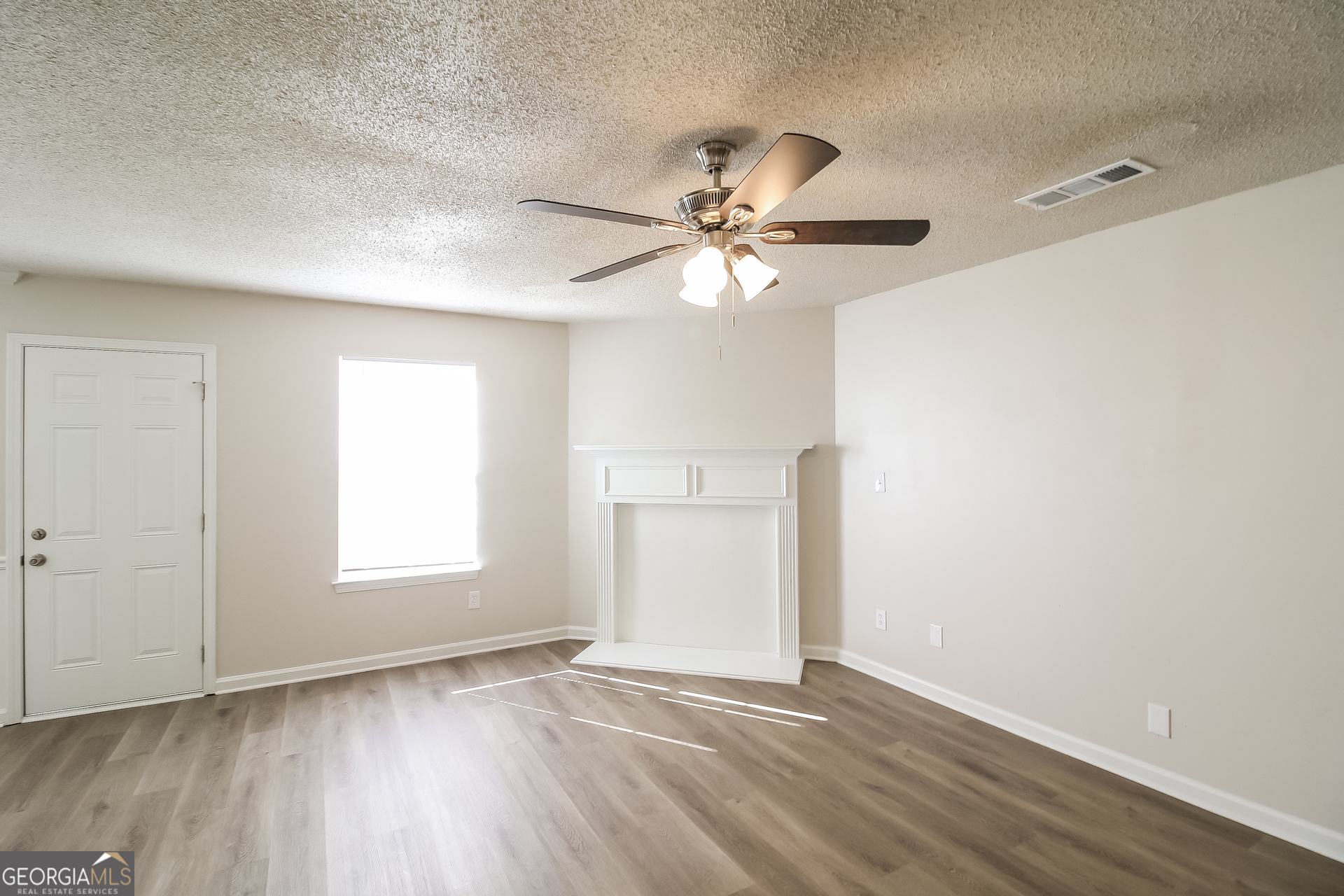 165 Colser Drive Covington, GA 30016 - Photo 5 of 17 wooden floor in an empty room with a window