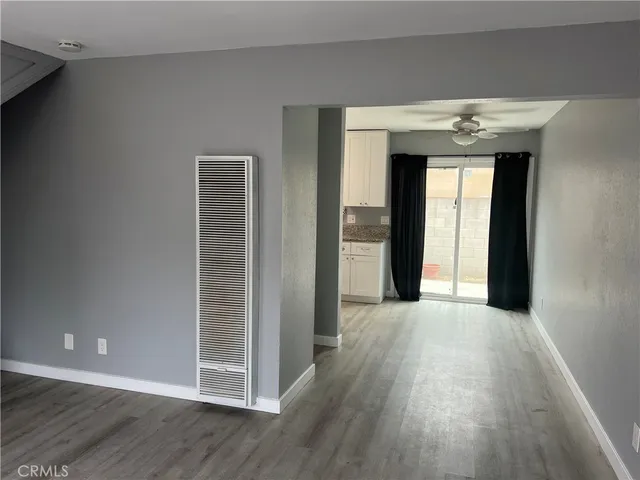 a view of a hallway with wooden floors