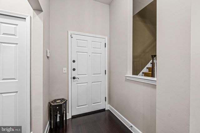 a view of room with hallway and wooden floor