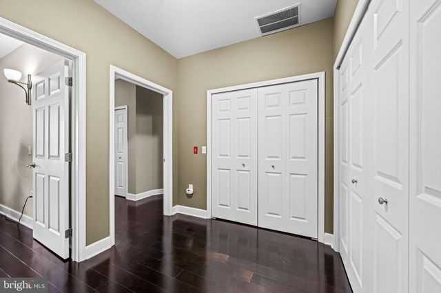 a view of a hallway with wooden floor and entryway