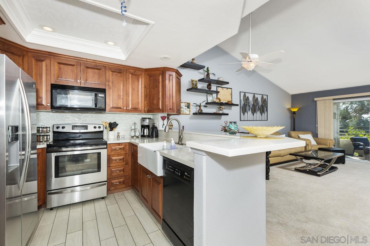 a kitchen with stainless steel appliances a stove sink microwave and cabinets