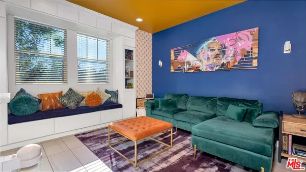 a living room with furniture and a open kitchen view