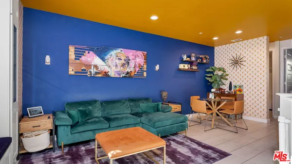 a living room with furniture a couch and a potted plant