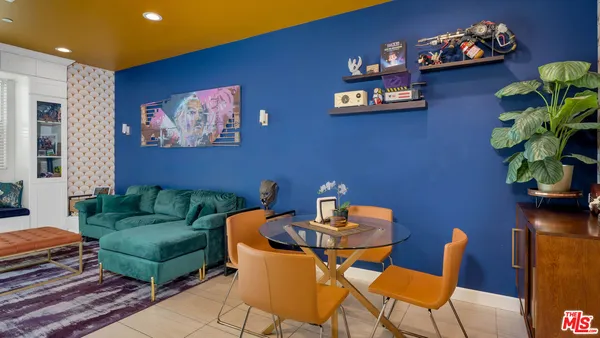 a dining room with furniture and wooden floor