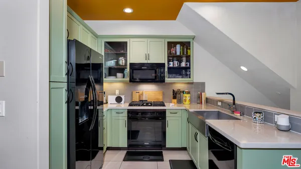 a kitchen with stainless steel appliances granite countertop a refrigerator stove and sink