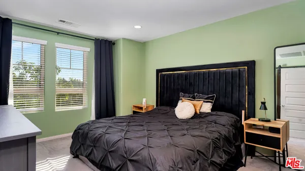 a spacious bathroom with a granite countertop sink and a large mirror