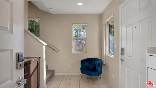 a view of a livingroom with furniture and a window