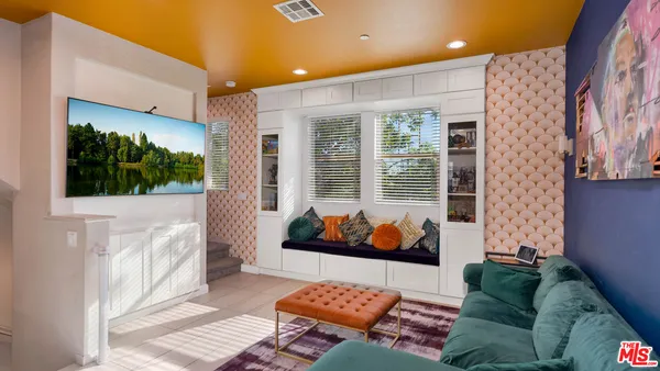 a living room with furniture and kitchen view