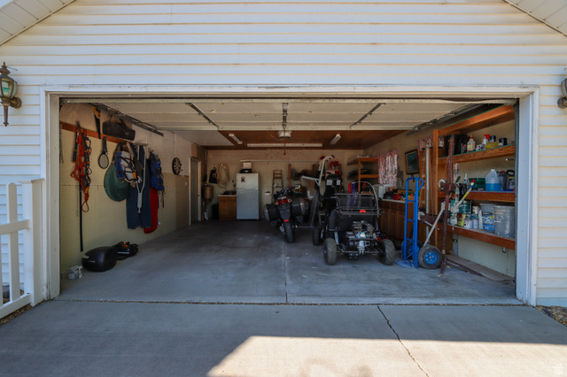 270 East 100 North Monroe, UT 84754 - Photo 7 of 65 Two-car garage with a concrete floor, overhead lighting, and built-in shelving