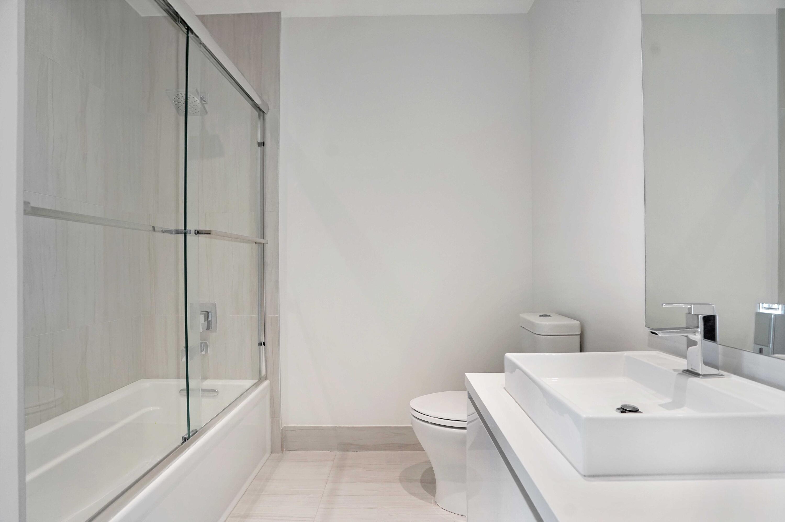 155 East Boca Raton Road, Unit 822 Boca Raton, FL 33432 - Photo 23 of 73 a bathroom with a white bath tub a toilet and a sink