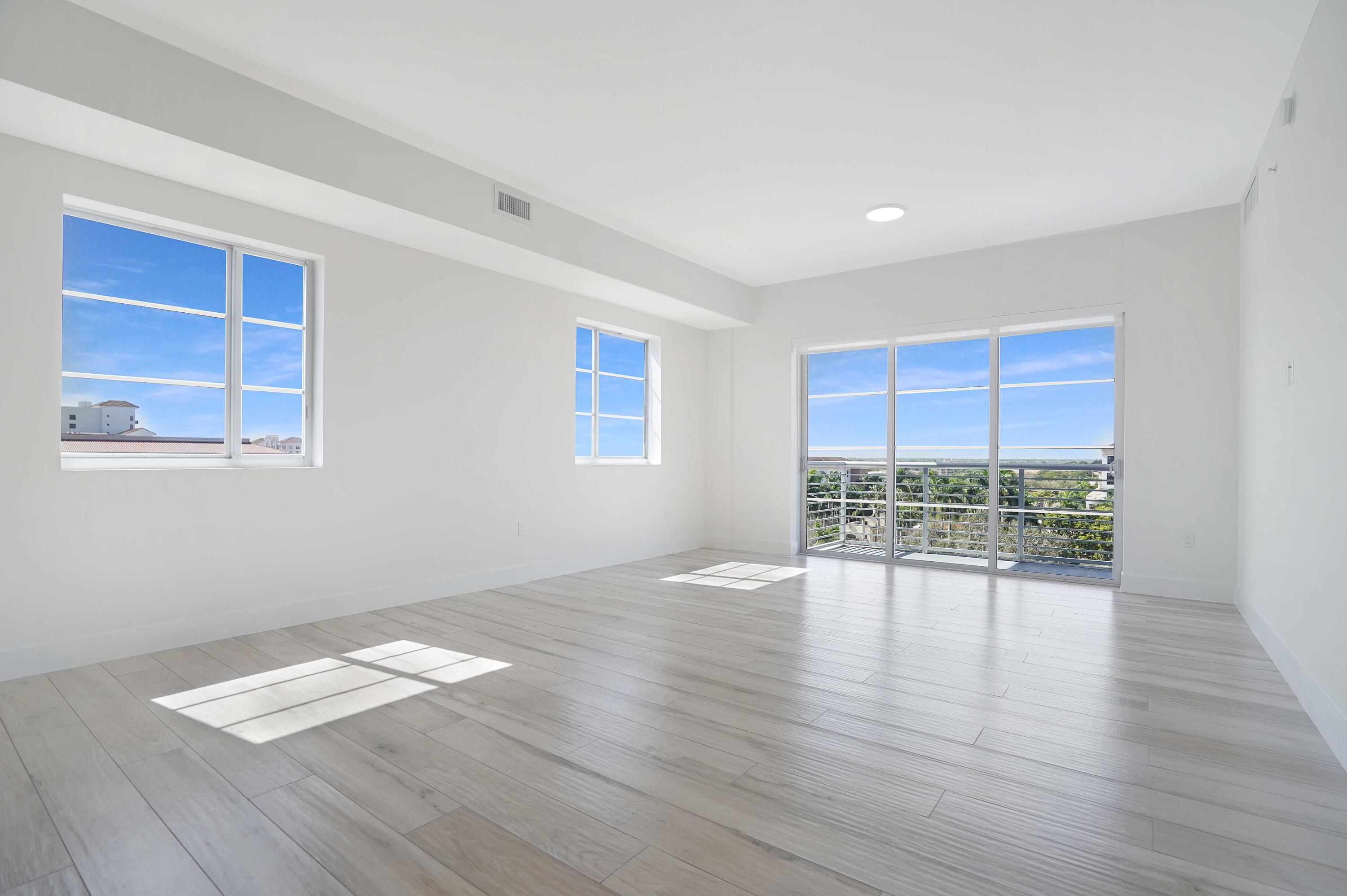155 East Boca Raton Road, Unit 822 Boca Raton, FL 33432 - Photo 24 of 73 a view of an empty room with wooden floor and a window