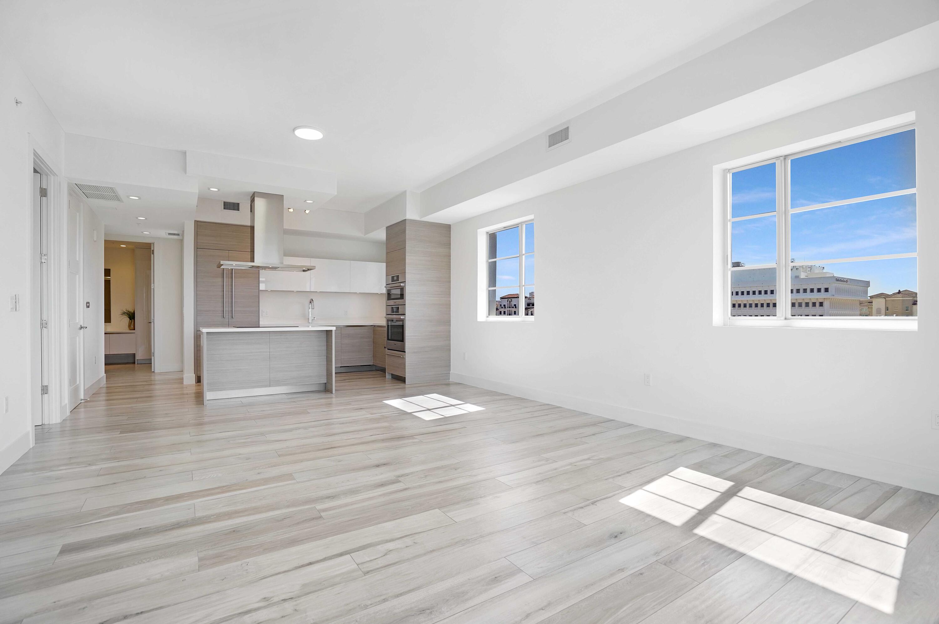 155 East Boca Raton Road, Unit 822 Boca Raton, FL 33432 - Photo 26 of 73 a view of empty room with wooden floor and windows