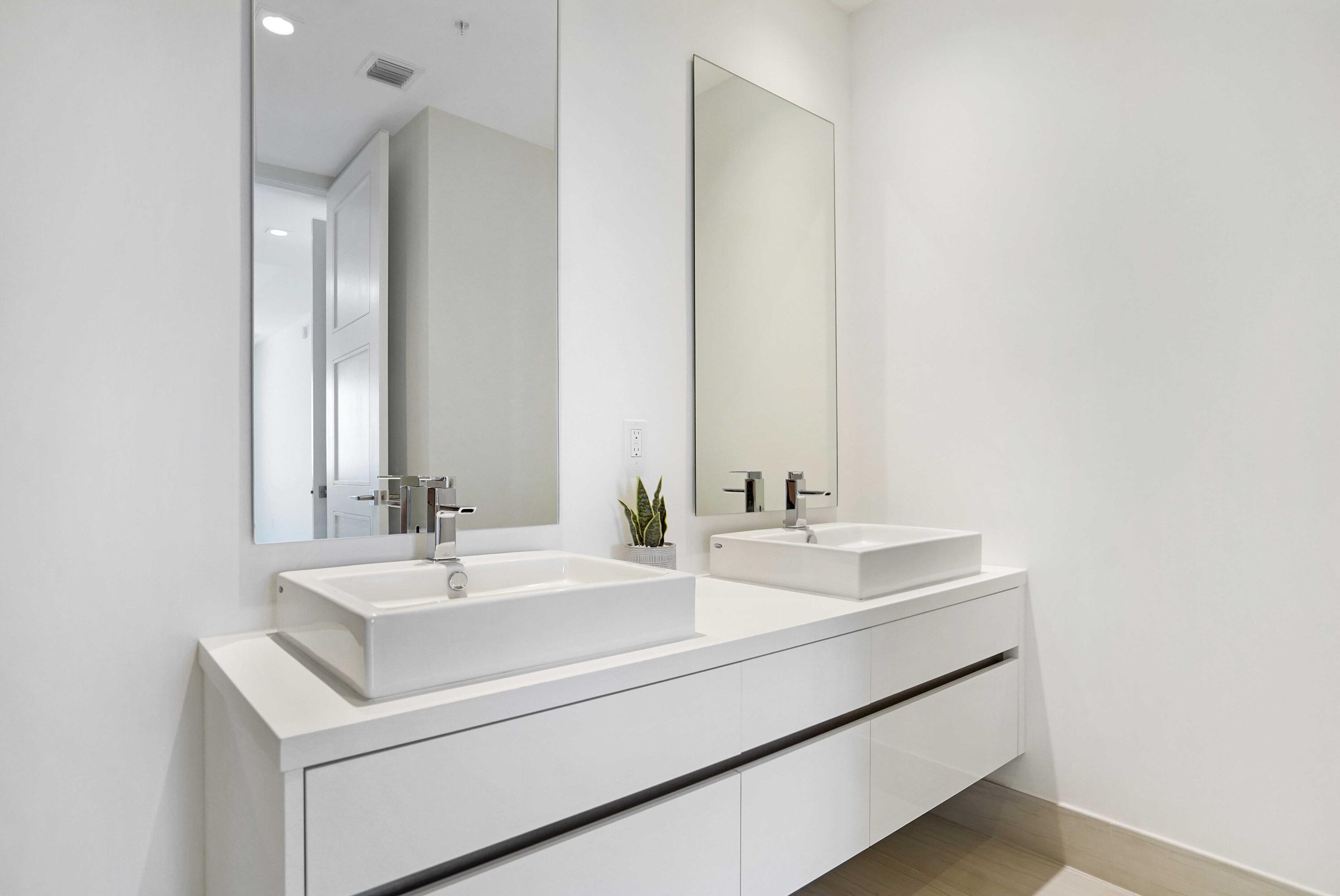 155 East Boca Raton Road, Unit 822 Boca Raton, FL 33432 - Photo 34 of 73 a bathroom with a sink and a mirror