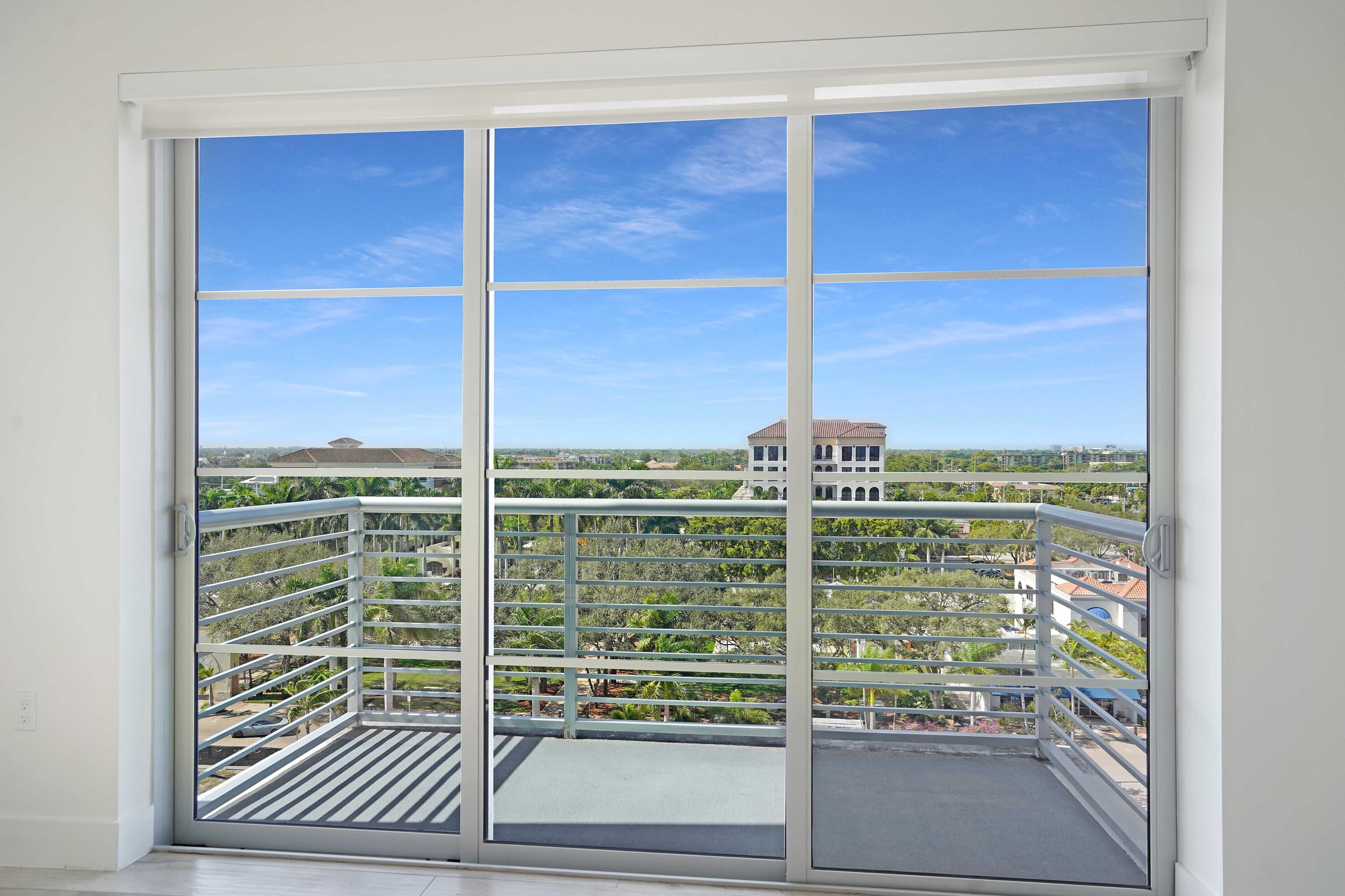 155 East Boca Raton Road, Unit 822 Boca Raton, FL 33432 - Photo 38 of 73 a view of a balcony with a floor to ceiling window and wooden floor
