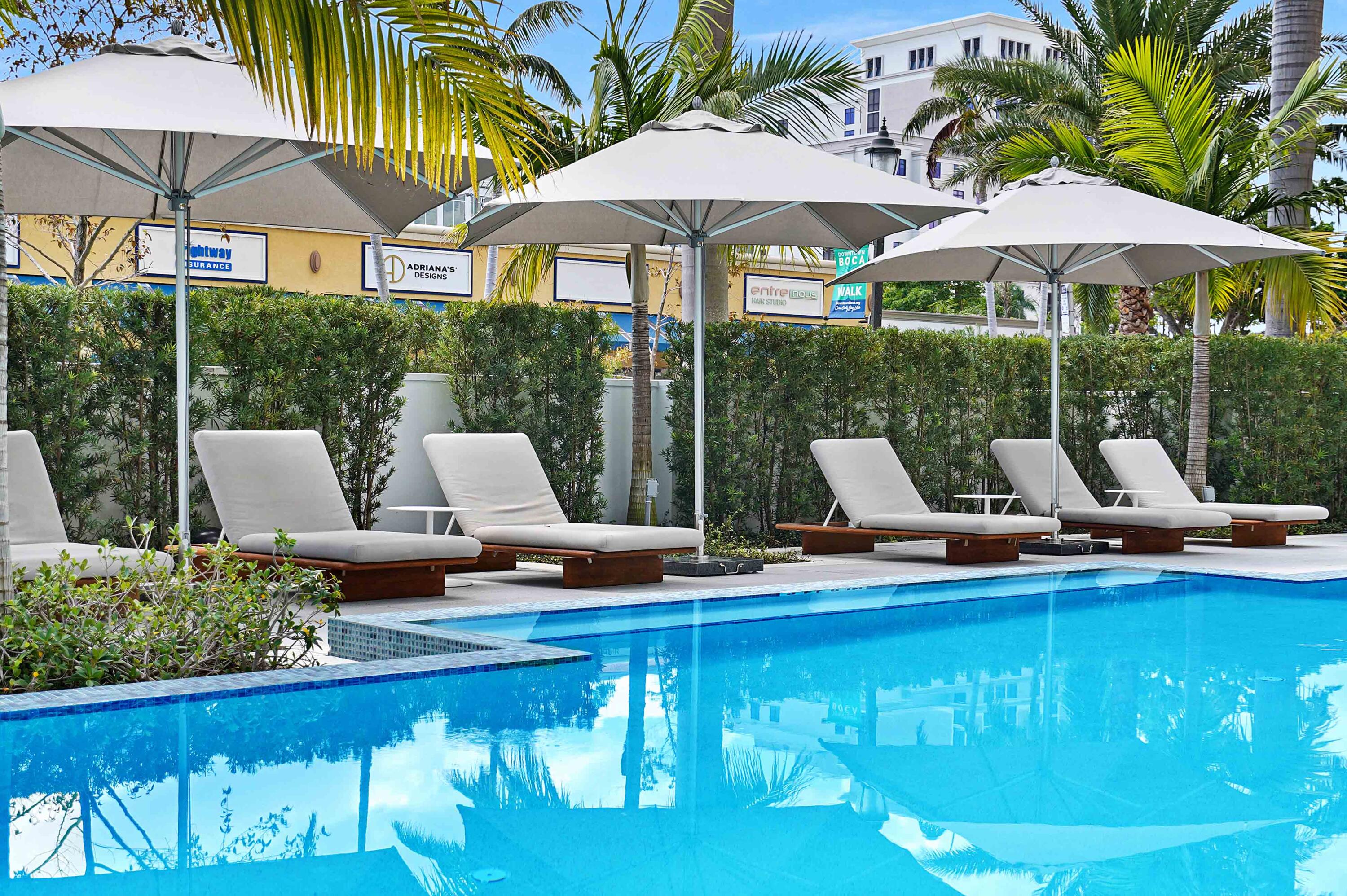 155 East Boca Raton Road, Unit 822 Boca Raton, FL 33432 - Photo 56 of 73 a view of a patio with chairs and umbrellas