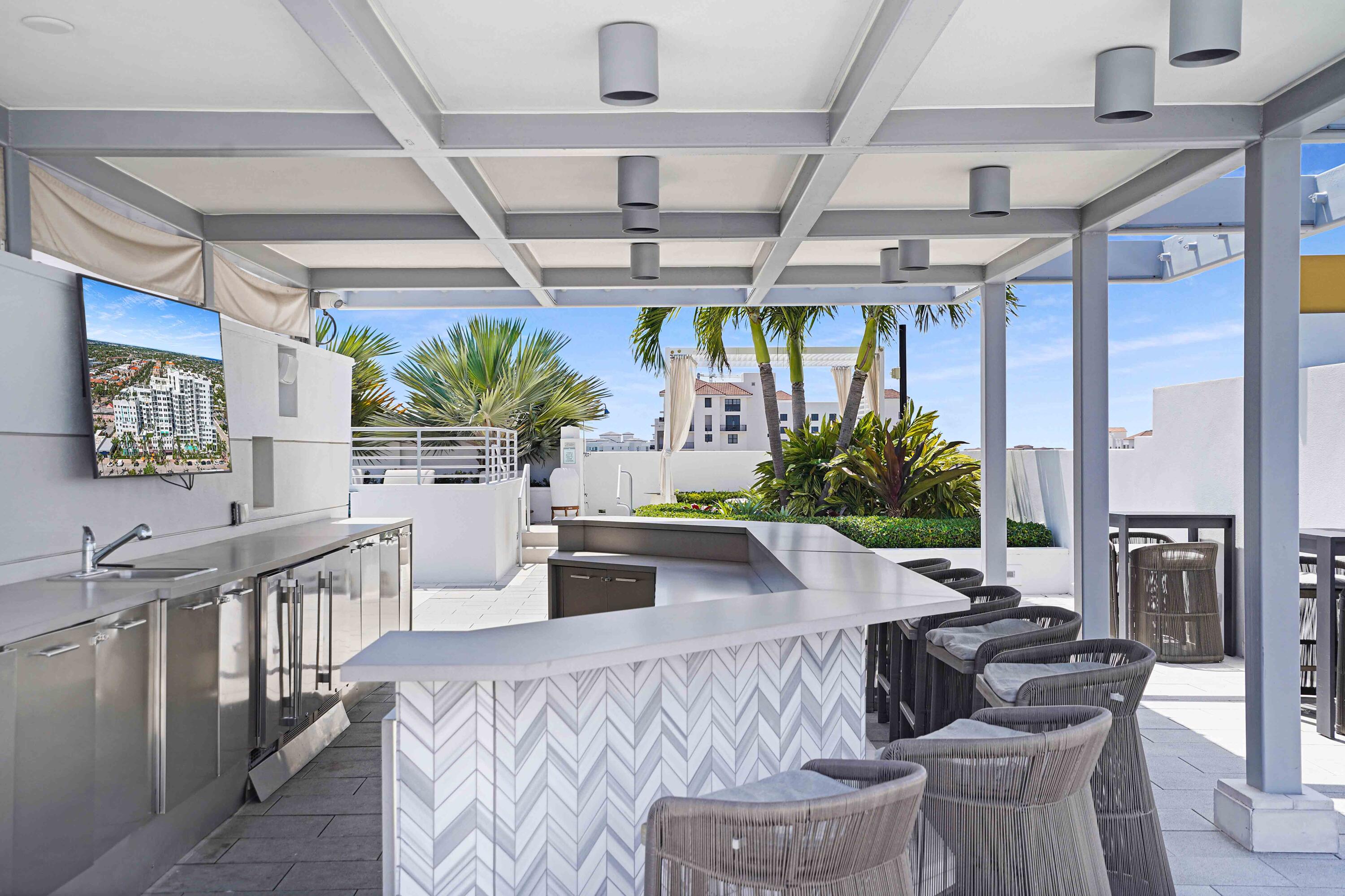 155 East Boca Raton Road, Unit 822 Boca Raton, FL 33432 - Photo 58 of 73 a view of a dining room with furniture a potted plant and wooden floor