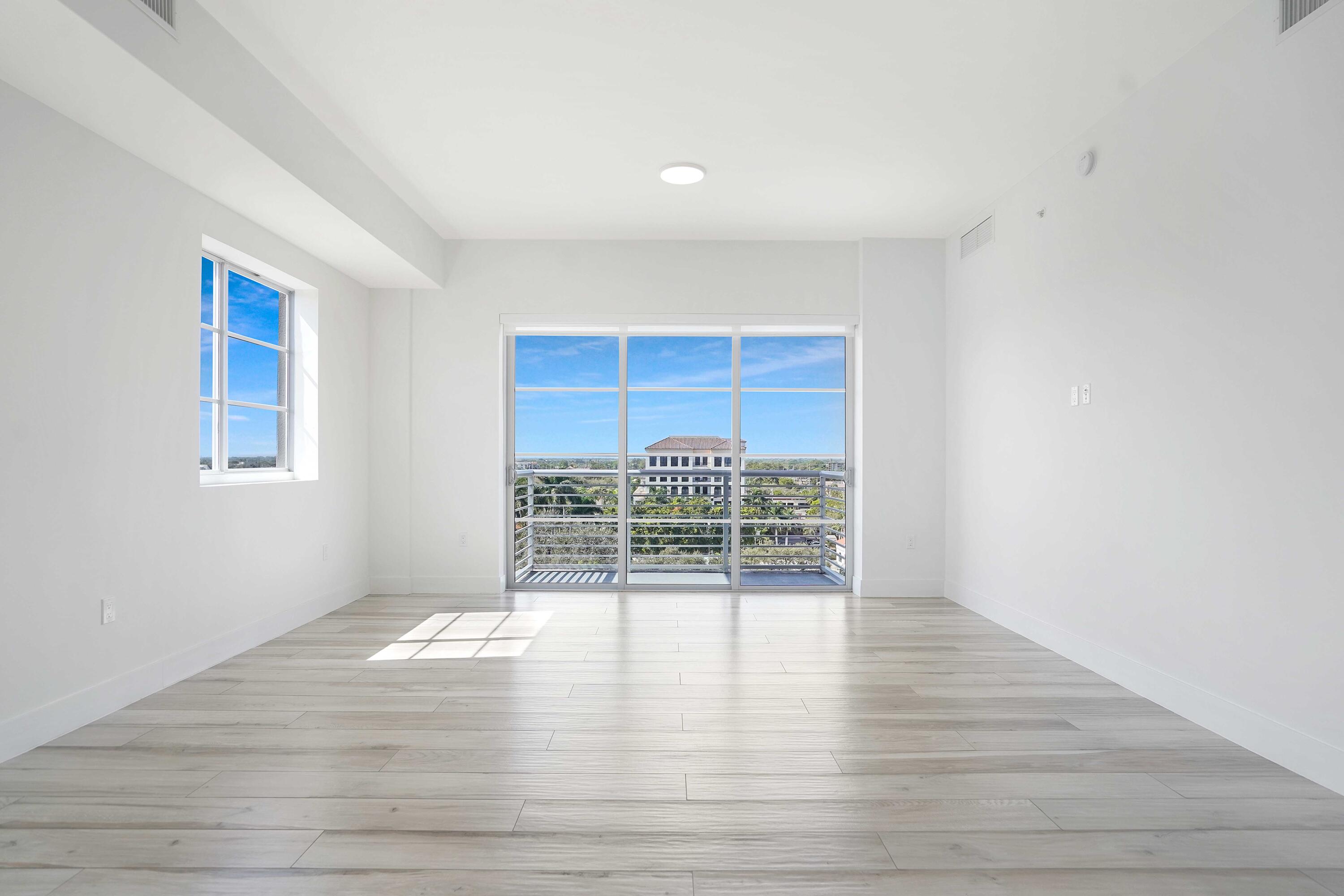 155 East Boca Raton Road, Unit 822 Boca Raton, FL 33432 - Photo 6 of 73 a view of empty room with wooden floor and floor to ceiling window