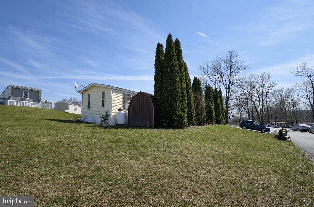 a view of a house with backyard and trees