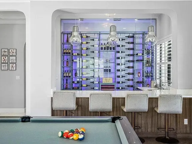 an aerial view of residential houses with outdoor space and lake view