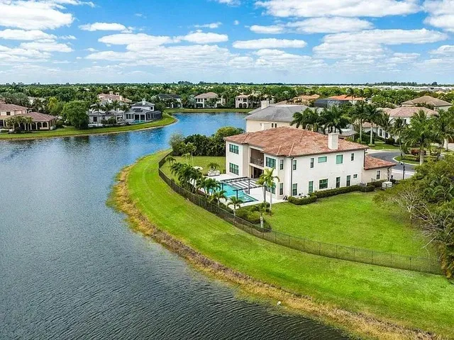 an aerial view of a house with a lake view