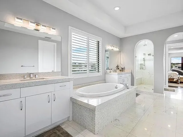 a kitchen with kitchen island a counter top space a sink stainless steel appliances and cabinets