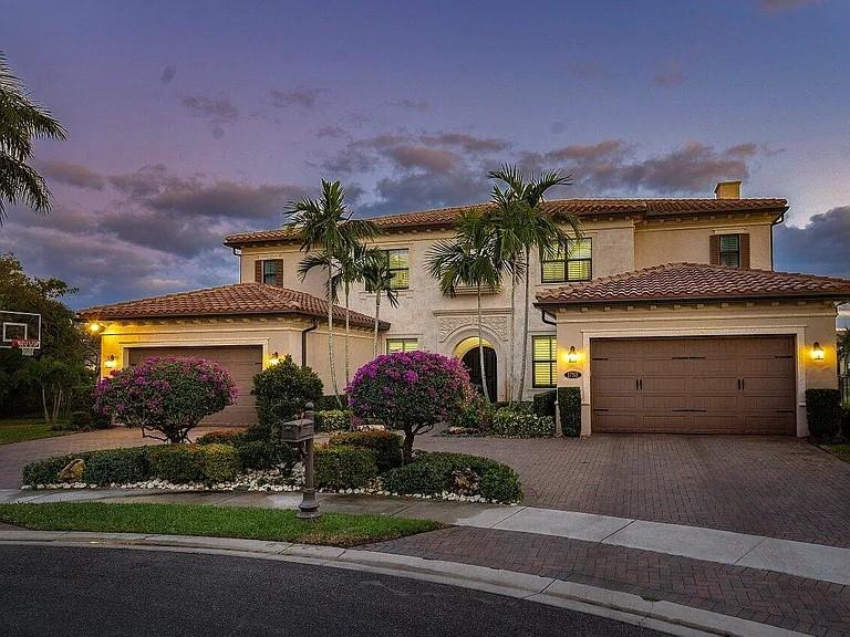 17511 Cadena Drive Boca Raton, FL 33496 - Photo 53 of 62 a front view of a house with a garden and a yard