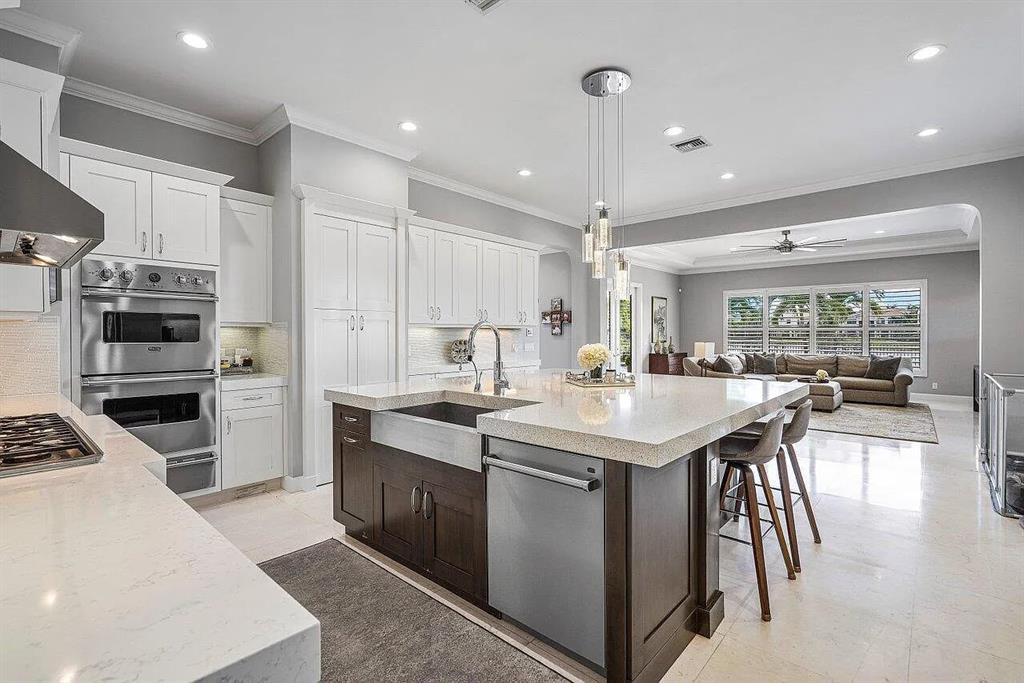 17511 Cadena Drive Boca Raton, FL 33496 - Photo 58 of 62 a kitchen with stainless steel appliances kitchen island granite countertop a sink and cabinets
