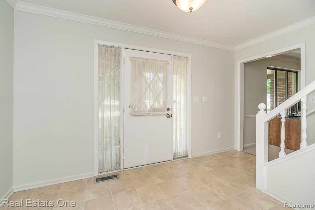 2355 Hillendale Drive Rochester, MI 48309 - Photo 40 of 44 Entryway featuring a white paneled door with sidelight, tile flooring, and white baseboards