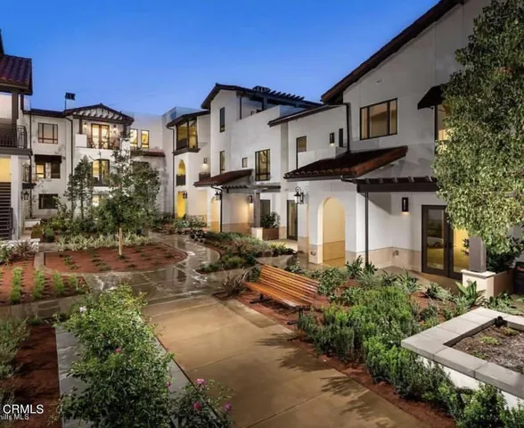 a front view of a house with yard and green space