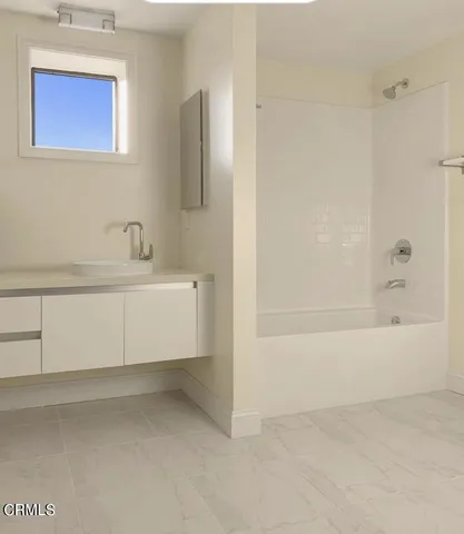a bathroom with a bathtub and a sink